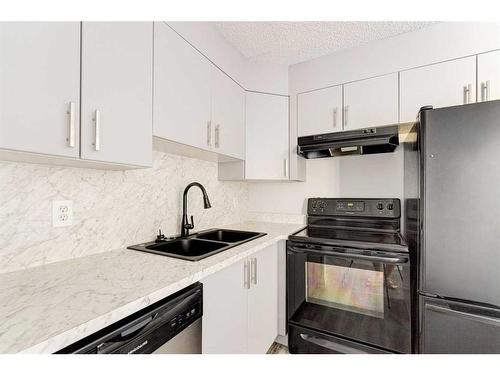 403-6000 Somervale Court Sw, Calgary, AB - Indoor Photo Showing Kitchen With Double Sink