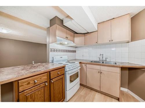 898 Rundlecairn Way Ne, Calgary, AB - Indoor Photo Showing Kitchen With Double Sink