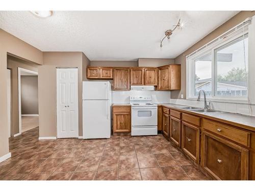 898 Rundlecairn Way Ne, Calgary, AB - Indoor Photo Showing Kitchen With Double Sink