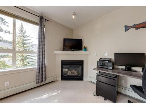 351-35 Richard Court Sw, Calgary, AB - Indoor Photo Showing Office With Fireplace