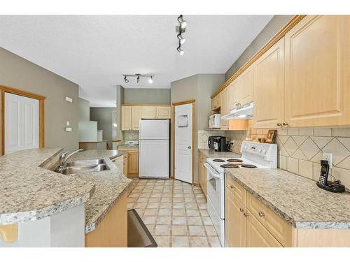 10 Cranston Drive Se, Calgary, AB - Indoor Photo Showing Kitchen With Double Sink