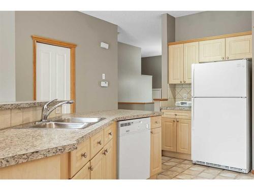 10 Cranston Drive Se, Calgary, AB - Indoor Photo Showing Kitchen With Double Sink
