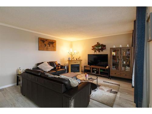 312-9800 Horton Road Sw, Calgary, AB - Indoor Photo Showing Living Room With Fireplace