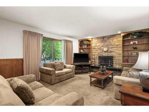 124 Oakhampton Place Sw, Calgary, AB - Indoor Photo Showing Living Room With Fireplace