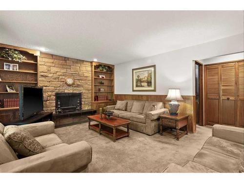 124 Oakhampton Place Sw, Calgary, AB - Indoor Photo Showing Living Room With Fireplace