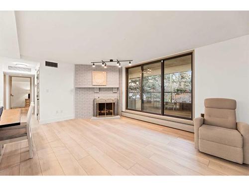 405-1215 Cameron Avenue Sw, Calgary, AB - Indoor Photo Showing Living Room With Fireplace