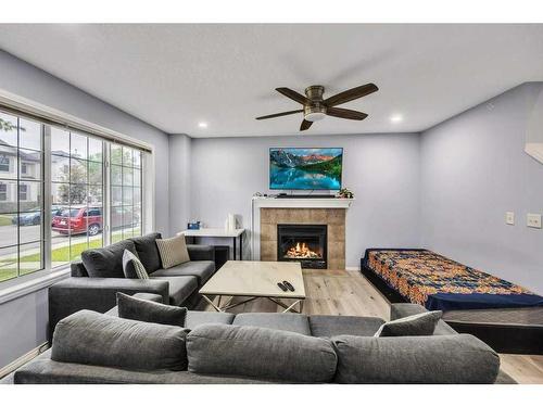 355 Saddlebrook Way Ne, Calgary, AB - Indoor Photo Showing Other Room With Fireplace