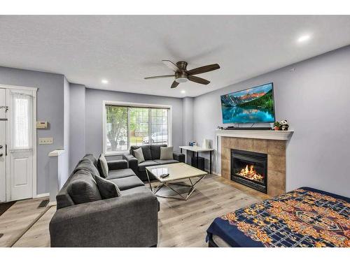 355 Saddlebrook Way Ne, Calgary, AB - Indoor Photo Showing Living Room With Fireplace