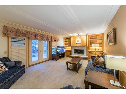 15 Patterson Drive Sw, Calgary, AB - Indoor Photo Showing Living Room With Fireplace