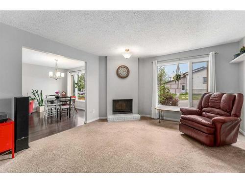 372 Whitlock Way Ne, Calgary, AB - Indoor Photo Showing Living Room With Fireplace