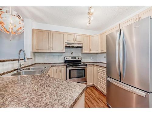 2321-8 Bridlecrest Drive Sw, Calgary, AB - Indoor Photo Showing Kitchen With Double Sink