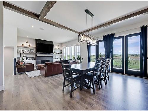 11 Chokecherry Ridge, Rural Rocky View County, AB - Indoor Photo Showing Dining Room With Fireplace