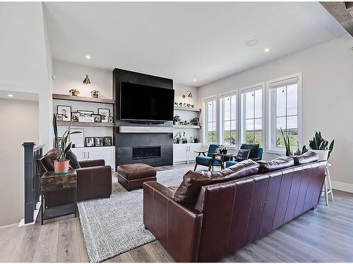 11 Chokecherry Ridge, Rural Rocky View County, AB - Indoor Photo Showing Living Room With Fireplace