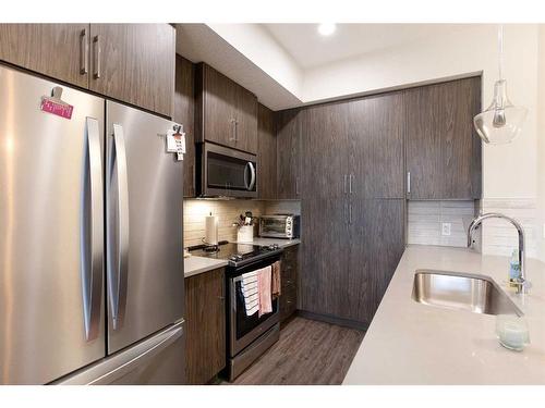 302-38 Quarry Gate Se, Calgary, AB - Indoor Photo Showing Kitchen With Upgraded Kitchen