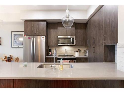 302-38 Quarry Gate Se, Calgary, AB - Indoor Photo Showing Kitchen With Double Sink With Upgraded Kitchen