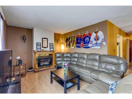 7916 47 Avenue Nw, Calgary, AB - Indoor Photo Showing Living Room With Fireplace