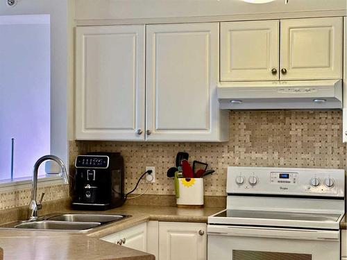 417-3000 Somervale Court Sw, Calgary, AB - Indoor Photo Showing Kitchen With Double Sink