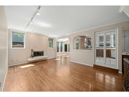 3339 Palliser Drive Sw, Calgary, AB - Indoor Photo Showing Living Room With Fireplace