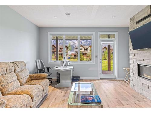 494 Stewart Creek Close, Canmore, AB - Indoor Photo Showing Living Room With Fireplace