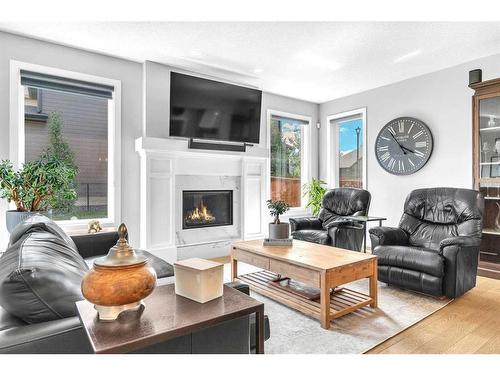 327 Shawnee Boulevard Sw, Calgary, AB - Indoor Photo Showing Living Room With Fireplace