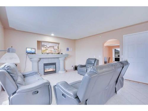 121 Taracove Place Ne, Calgary, AB - Indoor Photo Showing Living Room With Fireplace