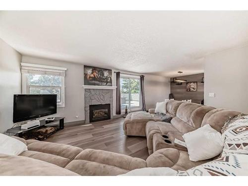 203-26 Glamis Green Sw, Calgary, AB - Indoor Photo Showing Living Room With Fireplace