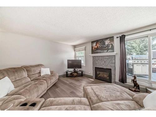 203-26 Glamis Green Sw, Calgary, AB - Indoor Photo Showing Living Room With Fireplace