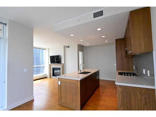 1615-222 Riverfront Avenue Sw, Calgary, AB - Indoor Photo Showing Kitchen With Fireplace With Double Sink