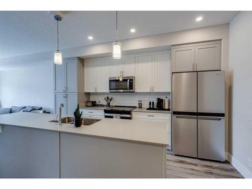 107-1702 17 Avenue Sw, Calgary, AB - Indoor Photo Showing Kitchen With Stainless Steel Kitchen With Upgraded Kitchen