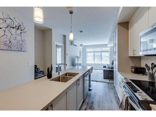 107-1702 17 Avenue Sw, Calgary, AB - Indoor Photo Showing Kitchen With Double Sink With Upgraded Kitchen