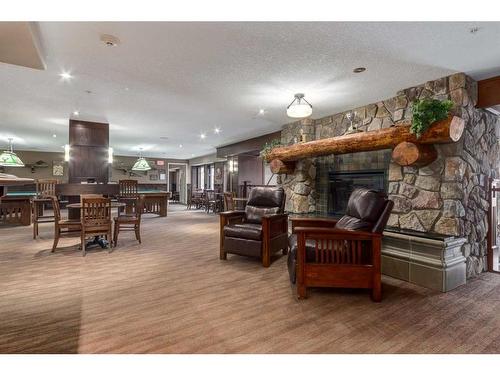 1127-2330 Fish Creek Boulevard Sw, Calgary, AB - Indoor With Fireplace