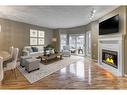 42 Hamptons Link Nw, Calgary, AB  - Indoor Photo Showing Living Room With Fireplace 