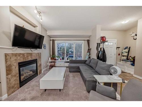 161 Walden Manor Se, Calgary, AB - Indoor Photo Showing Living Room With Fireplace