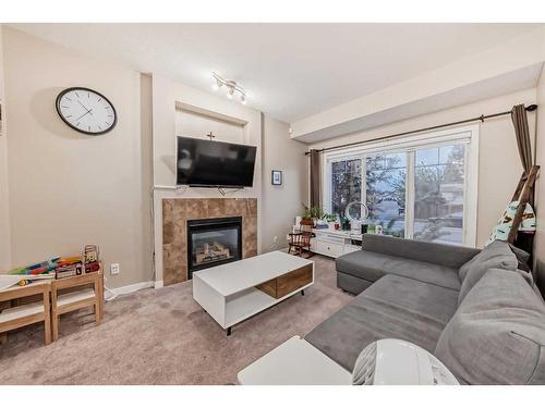 161 Walden Manor Se, Calgary, AB - Indoor Photo Showing Living Room With Fireplace