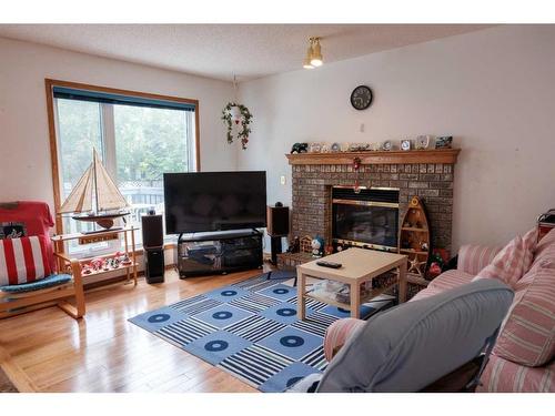 319 Hidden Vale Place Nw, Calgary, AB - Indoor Photo Showing Living Room With Fireplace