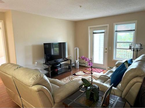 205-5000 Somervale Court Sw, Calgary, AB - Indoor Photo Showing Living Room