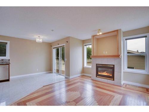 4 Coventry Way Ne, Calgary, AB - Indoor Photo Showing Living Room With Fireplace