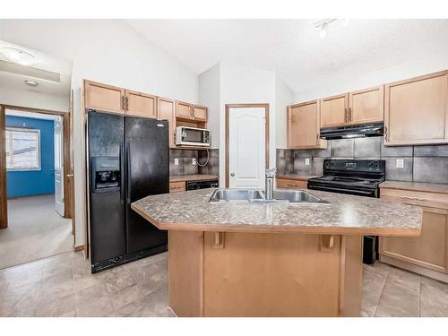 86 Silverado Saddle Crescent Sw, Calgary, AB - Indoor Photo Showing Kitchen With Double Sink