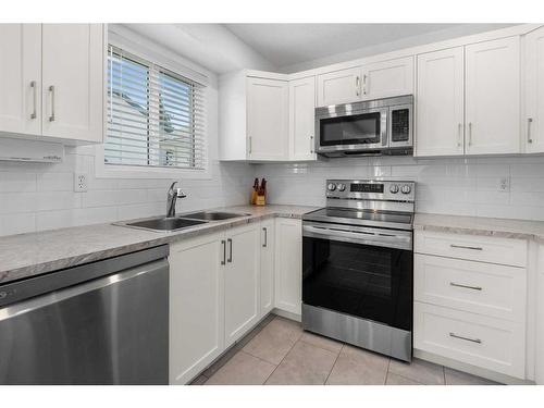 105 Somerset Close Sw, Calgary, AB - Indoor Photo Showing Kitchen With Double Sink