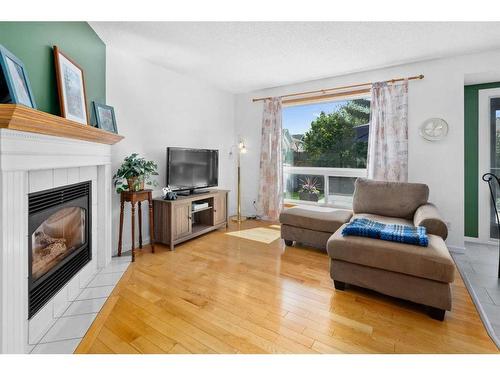105 Somerset Close Sw, Calgary, AB - Indoor Photo Showing Living Room With Fireplace