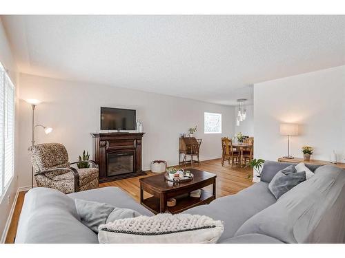 10712 Maplecrest Road Se, Calgary, AB - Indoor Photo Showing Living Room With Fireplace