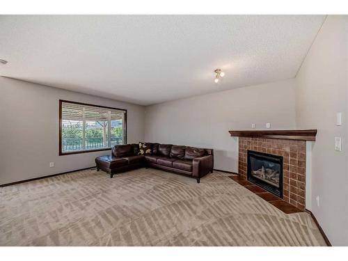 328 Eversyde Way Sw, Calgary, AB - Indoor Photo Showing Living Room With Fireplace