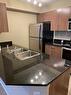 4312-403 Mackenzie Way Sw, Airdrie, AB  - Indoor Photo Showing Kitchen With Double Sink 