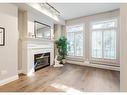 8102-400 Eau Claire Avenue Sw, Calgary, AB  - Indoor Photo Showing Living Room With Fireplace 