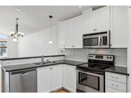 22 New Brighton Green Se, Calgary, AB - Indoor Photo Showing Kitchen With Double Sink With Upgraded Kitchen