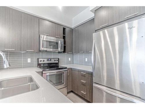 1304-175 Silverado Boulevard Sw, Calgary, AB - Indoor Photo Showing Kitchen With Stainless Steel Kitchen With Double Sink With Upgraded Kitchen