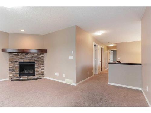 34 Cranarch Landing Se, Calgary, AB - Indoor Photo Showing Other Room With Fireplace