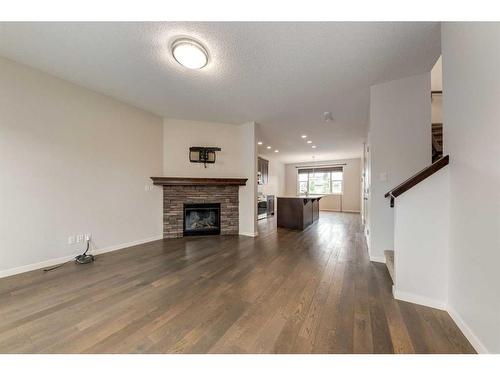 77 Cranford Place Se, Calgary, AB - Indoor Photo Showing Living Room With Fireplace