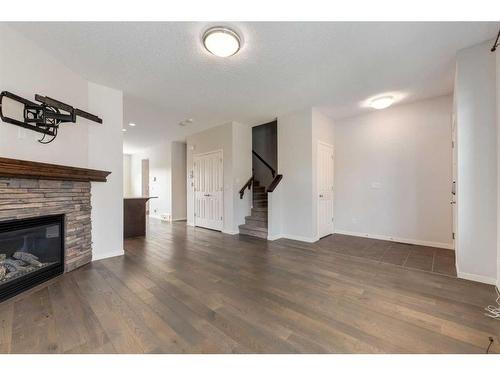 77 Cranford Place Se, Calgary, AB - Indoor Photo Showing Living Room With Fireplace