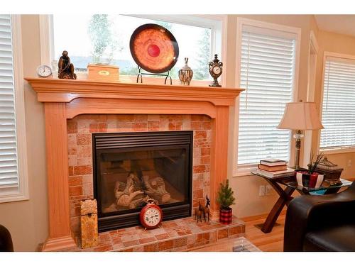 90 Cougarstone Close Sw, Calgary, AB - Indoor Photo Showing Living Room With Fireplace